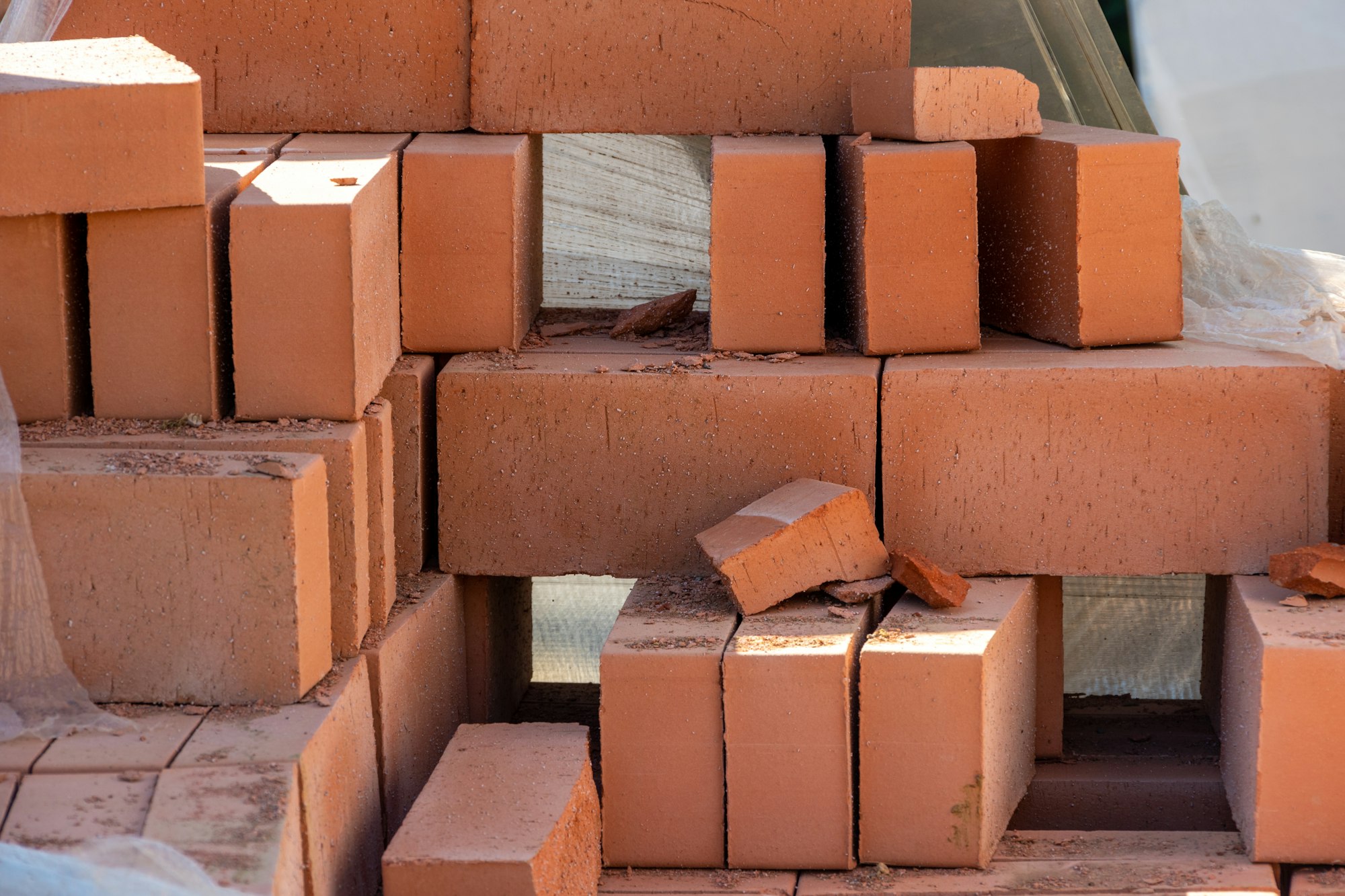 red bricks in a construction warehouse on the street. Building material red brick with holes.